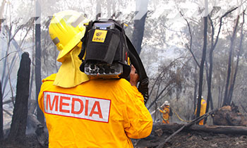 Media - Cameraman A camera operator filming a hazard reduction burn